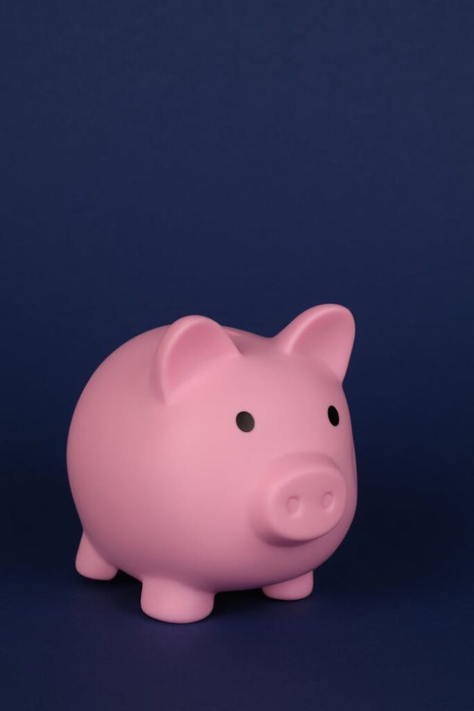 Charming close-up of a pink piggy bank set against a blue backdrop, perfect for finance concepts.